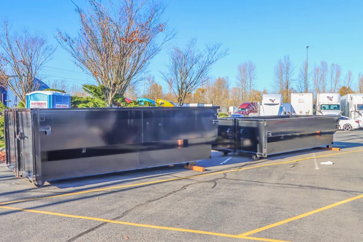 Professional dumpster rental service with roll-off container on residential driveway in Lone Tree